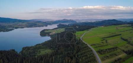 Photo for An aerial view of Lake Czorsztyn and Pieniny with a cloudy blue sky in the background, Poland - Royalty Free Image