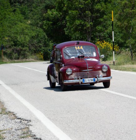 Photo for URBINO - ITALY - JUN 16 - 2022 : RENAULT 4 CV 1948 on an old racing car in rally Mille Miglia 2022 the famous italian historical race - Royalty Free Image