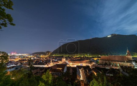 Photo for A Beautiful view of Brasov city from the White Tower under blue twilight sky in Transylvania, Romania - Royalty Free Image