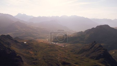 Photo for A landscape of range green mountains with hiing trails and misty sky on the horizon - Royalty Free Image