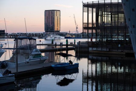 Photo for A Melbourne city dockland harbour with boats on the water and buildings in the background - Royalty Free Image