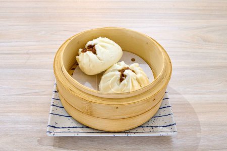 Photo for A closeup of Char siu bao in a wooden bowl. Chinese cuisine. - Royalty Free Image