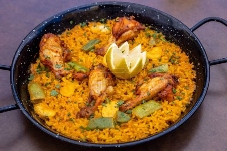Photo for A closeup of Paella served on a pan in a restaurant - Royalty Free Image