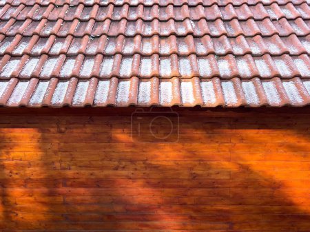 Photo for A wooden cabin with snow on the roof shingles - Royalty Free Image