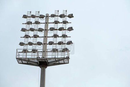 Téléchargez les photos : Un plan à angle bas de hautes lumières de stade dans un ciel bleu - en image libre de droit