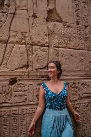 Photo for A vertical shot of a young female tourist posing near a historic pyramid in Egypt - Royalty Free Image