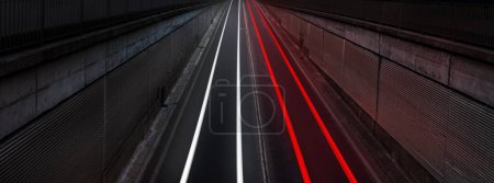Photo for Light trails of cars moving along highway long exposure at night. White front and red back lights. - Royalty Free Image