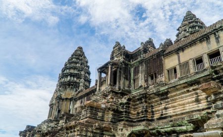 Photo for A low angle exterior of Buddhism Angkor Wat in Siem Reap, Cambodia with blue sky - Royalty Free Image