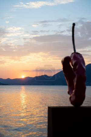 Photo for A sculpture of chilli by Giuseppe Carta near Lake Iseo at sunset - Royalty Free Image