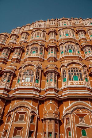 Photo for A vertical, low-angle shot of a mesmerizing exterior of The Hawa Mahal palace in Jaipur, India, with a blue sky above - Royalty Free Image