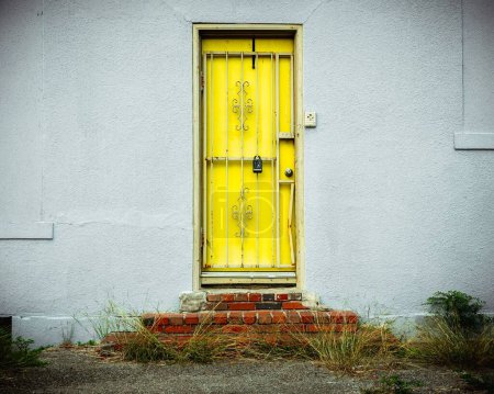Photo for An old yellow door above red brick steps - Royalty Free Image