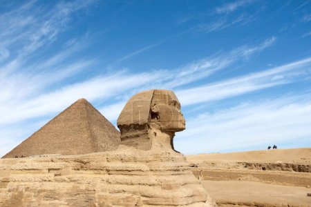 Photo for The ancient Egyptian pyramids and the Great Sphinx of Giza against a blue cloudy sky on a sunny day - Royalty Free Image