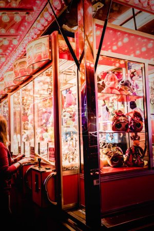 Photo for A vertical shot of illuminated claw machines at the annual street fair in St Giles, Oxford - Royalty Free Image
