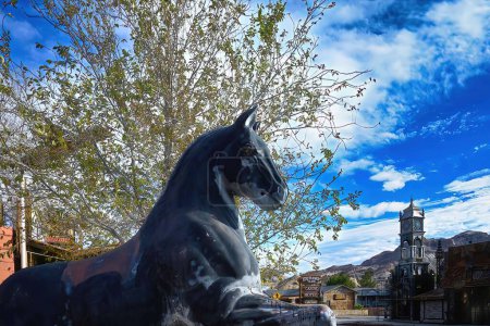Téléchargez les photos : Scène d'une ville fantôme abandonnée avec une statue de cheval noir avec une vallée de la mort, Beatty, Nevada, États-Unis - en image libre de droit