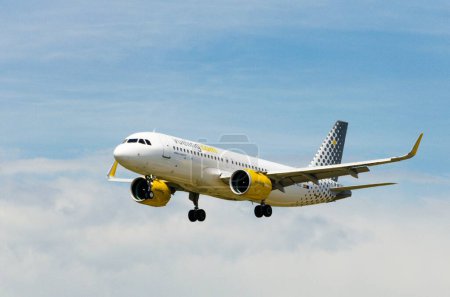 Photo for An Airbus A320 airplane of the Vueling company, landing at Josep Tarradellas Barcelona-El Prat Airport - Royalty Free Image