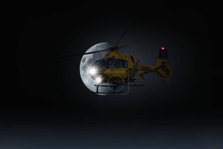 Photo for An ADAC helicopter in front of half moon Composing - Royalty Free Image
