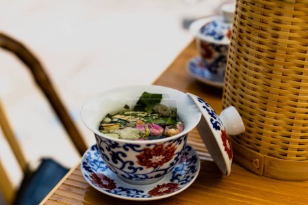 Photo for A closeup of a typical Chinese tea cup with an open lid - Royalty Free Image