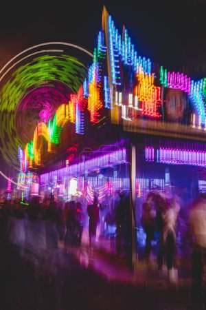 Photo for A vertical shot of glowing illuminated rides at the annual street fair in St Giles, Oxford - Royalty Free Image