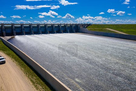 Photo for An aerial drone view of a dam over Lake Diefenbaker on a sunny day - Royalty Free Image