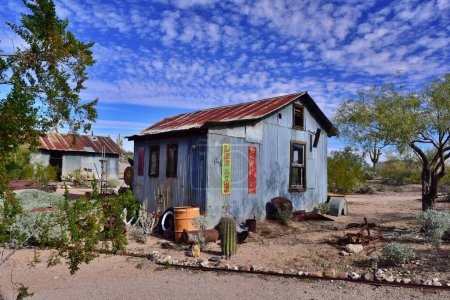 Photo for An old metal building in the Vulture City Ghost town located in Wickenbury, AZ against the blue sky and clouds. - Royalty Free Image