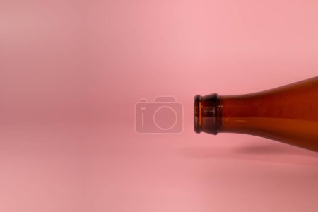 Photo for A brown bottle on a pink background with a copy space - Royalty Free Image