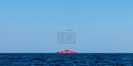 Photo for A red ship on the sea surface under the blue sky - Royalty Free Image