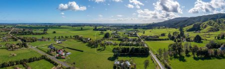 Photo for A panoramic shot of a rural agricultural landscape with fields and houses in Levin, New Zealand - Royalty Free Image