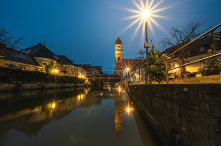 Photo for The view of Basilika St. Martin and buildings on the banks of Amberg city canal in the evening - Royalty Free Image