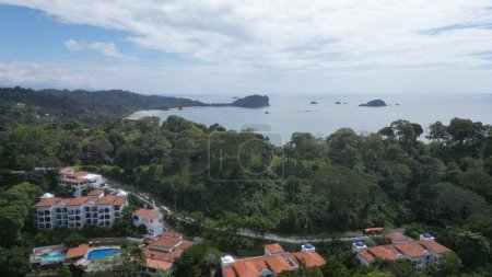 Photo for An aerial shot over a resort surrounded by green trees and a sea, Manuel Antonio Park - Royalty Free Image