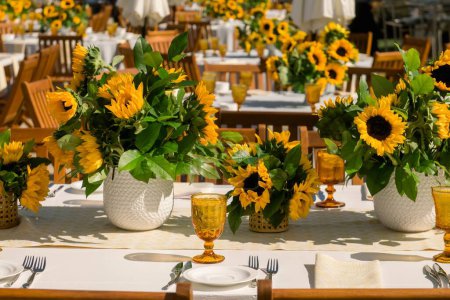 Photo for A beautiful shot of sunflower decorations and dinnerware on a table - Royalty Free Image