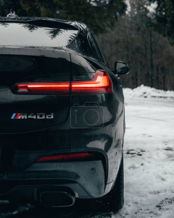 Photo for A vertical shot of a BMW X4M parked near the road in winter - Royalty Free Image