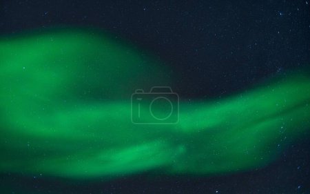Photo for A beautiful shot of bright green aurora northern lights over mountains in Norway - Royalty Free Image