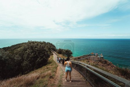 Photo for A girl looking out from Cape Byron, at the ocean. - Royalty Free Image
