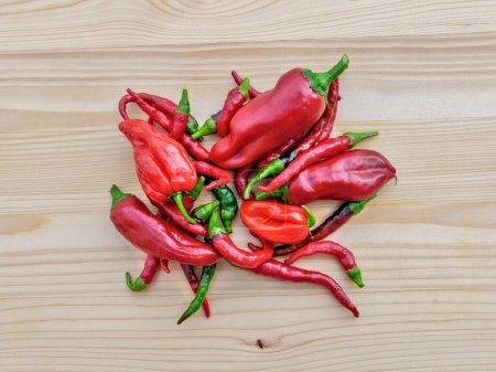 Photo for A top view of chilli peppers on a wooden board background - Royalty Free Image