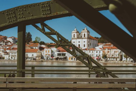 Téléchargez les photos : Un beau cliché des bâtiments vus à travers le pont à Alcacer do Sal, Portugal - en image libre de droit