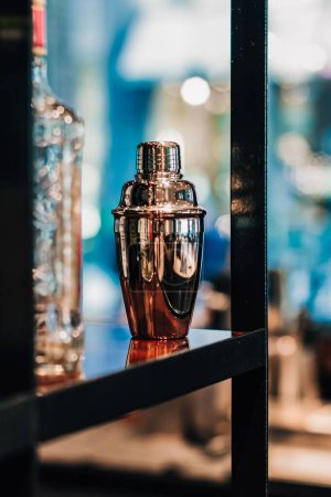 Photo for A vertical shot of a cocktail shaker on a shelf - Royalty Free Image