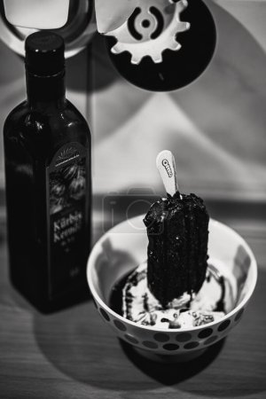 Photo for A grayscale closeup of an oreo ice cream on a table - Royalty Free Image