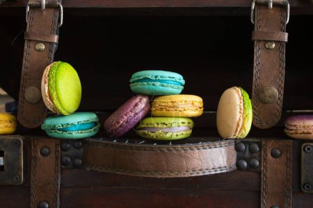 Photo for A colorful macaroons on a brown leather bag - Royalty Free Image