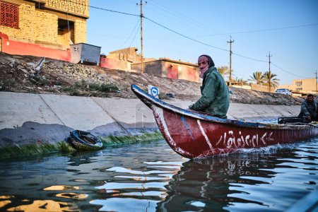 Téléchargez les photos : Un vieil homme sur un bateau dans les marais, les marais de Mésopotamie en Irak - en image libre de droit