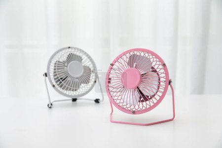 Photo for A closeup of small pink and white fans on a white table - Royalty Free Image