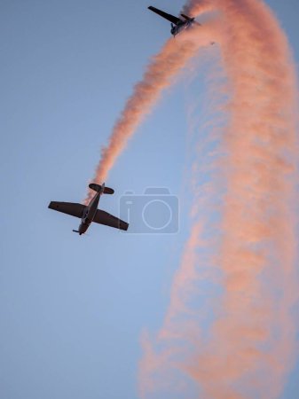 Photo for The flying combat aircrafts with yellow traces in the sky - Royalty Free Image