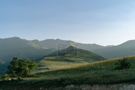 Photo for A beautiful landscape of a green valley with the mountains in the background on a sunny day - Royalty Free Image