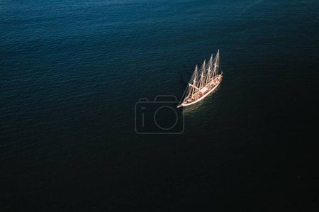 Photo for An aerial view of a white ship without sails in the blue sea - Royalty Free Image