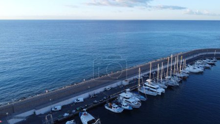 Photo for A drone shot of boats on the harbor next to Bordighera, Italy - Royalty Free Image