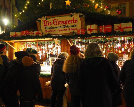 Foto de Personas en una tienda de vidrio comprando hermosas luces de Navidad en un mercado de Navidad en Darmstadt, Alemania - Imagen libre de derechos