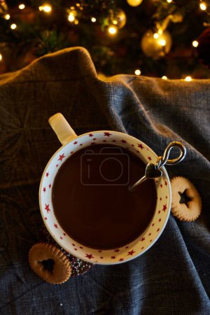 Photo for A vertical shot of a cup of hot chocolate with Christmas lights - Holidays concept - Royalty Free Image