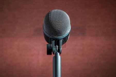 Photo for A closeup shot of a metal microphone with a pole isolated on a red background - Royalty Free Image