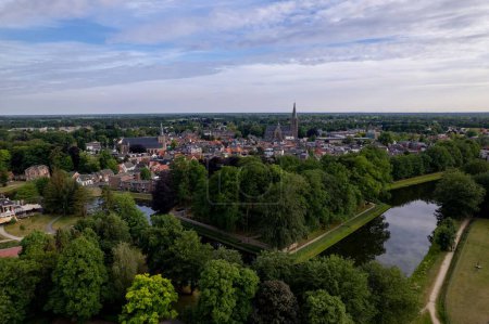 Photo for Aerial view showing historic Dutch city Groenlo with church Saint Calixtusbasiliek rising above the authentic medieval rooftops - Royalty Free Image