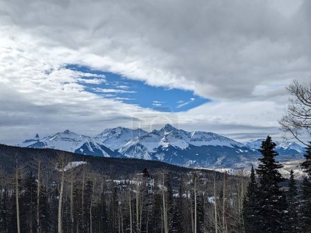 Téléchargez les photos : La vue sur la forêt d'hiver avec des montagnes en arrière-plan. - en image libre de droit