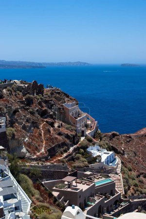 Photo for A vertical aerial view of buildings on a hill with a blue ocean in the background in Santorini, Greece - Royalty Free Image
